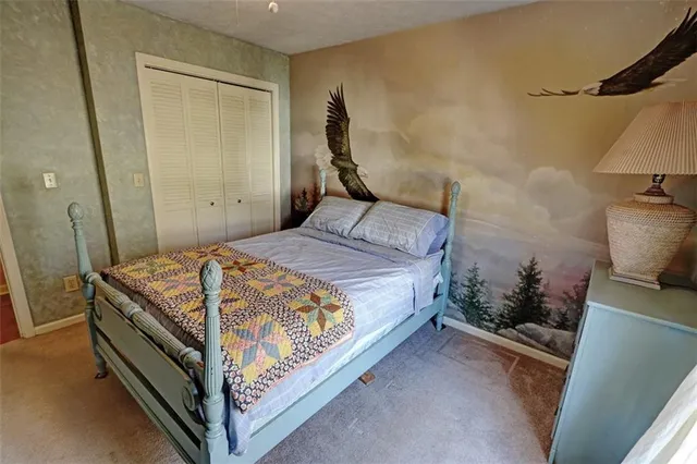 a bathroom with a granite countertop sink toilet and shower a mirror
