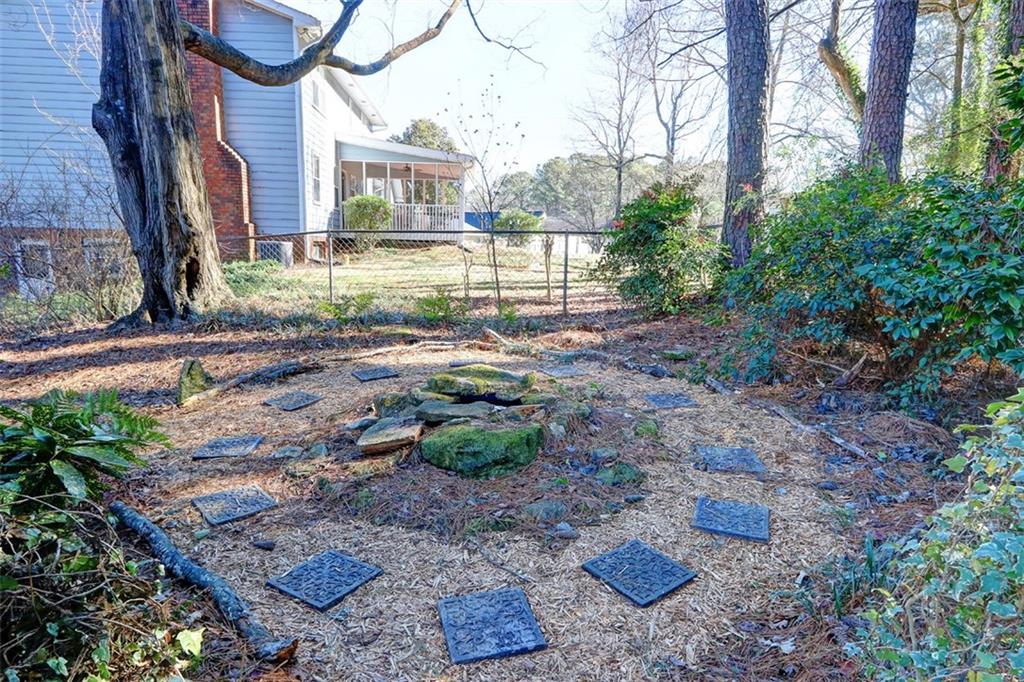 253 Newport Road Southwest Lilburn, GA 30047 - Photo 27 of 40 a view of a brick house next to a yard