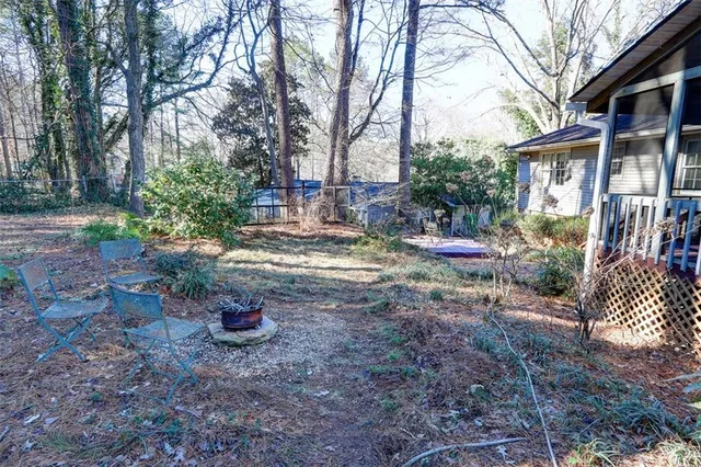 a view of a brick house next to a yard