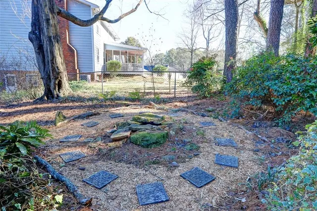 a view of a backyard with plants and trees