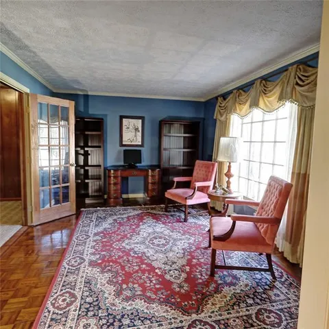 a living room with furniture fireplace and a window