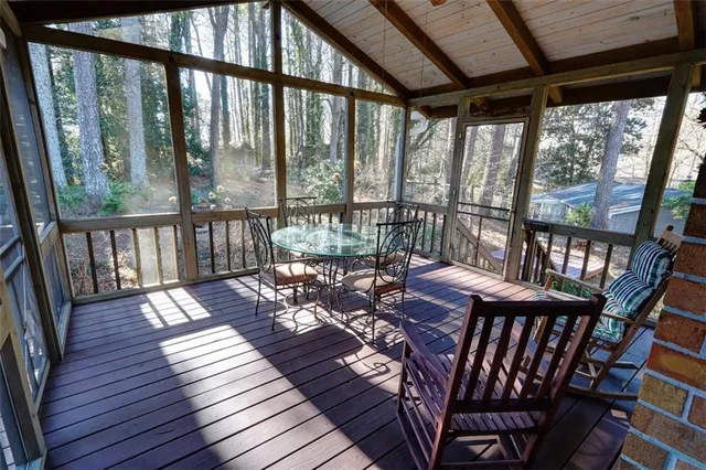 a view of a dining room with furniture wooden floor and a potted plant