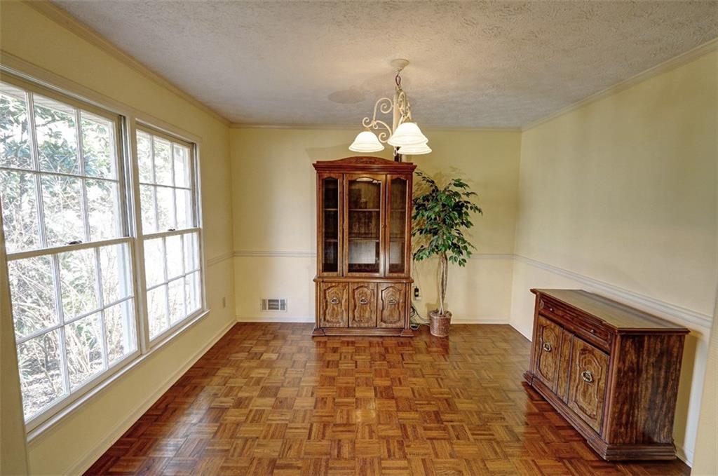 253 Newport Road Southwest Lilburn, GA 30047 - Photo 10 of 40 a living room with furniture and a chandelier