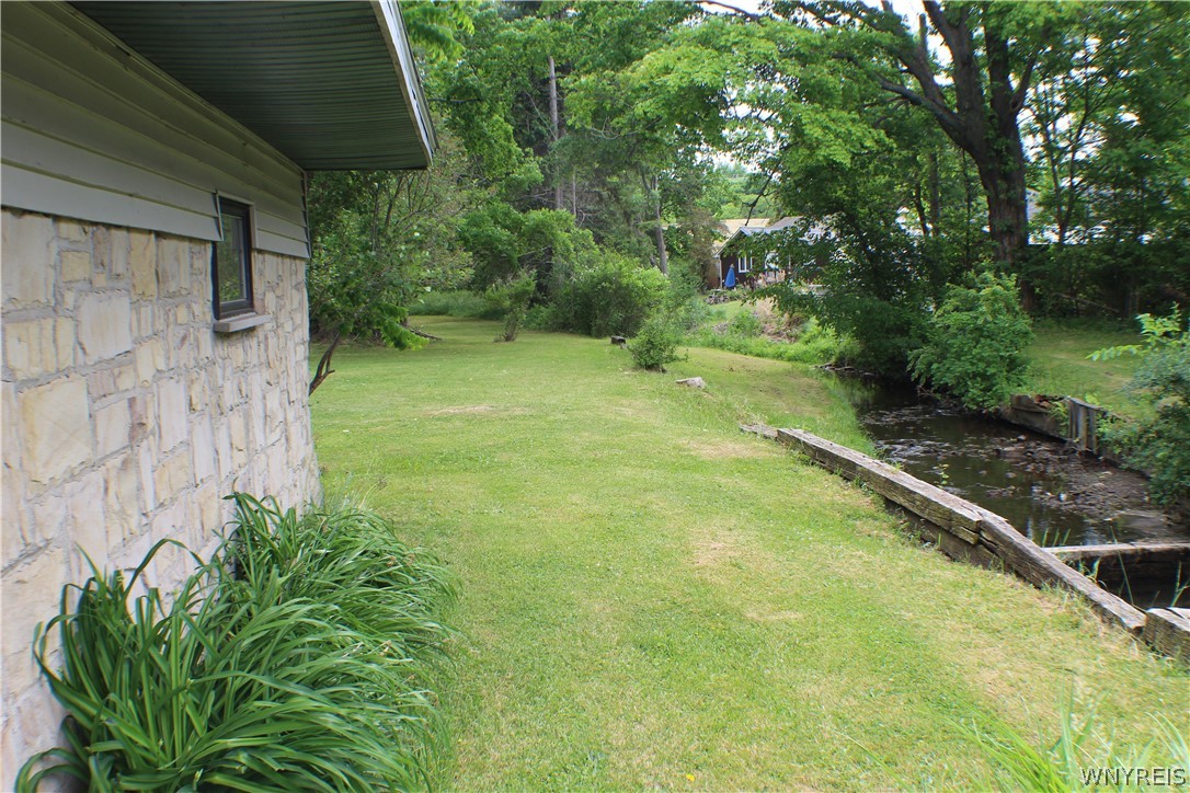94 Longview Avenue Ellicott, NY 14701 - Photo 15 of 48 side lawn leading down garage to backyard