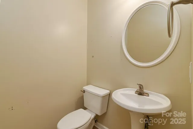 a bathroom with a sink mirror and toilet
