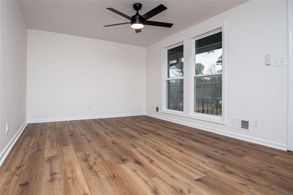 757 North Burnt Hickory Road Douglasville, GA 30134 - Photo 11 of 51 a view of an empty room with a window and wooden floor