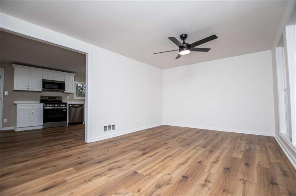 757 North Burnt Hickory Road Douglasville, GA 30134 - Photo 12 of 51 an empty room with wooden floor and a ceiling fan
