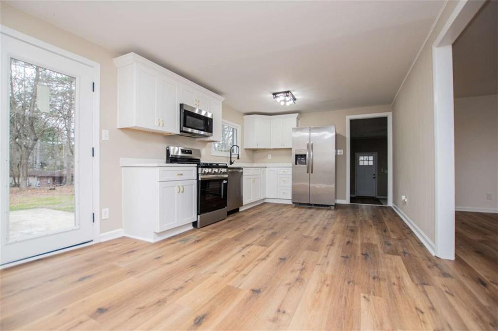 757 North Burnt Hickory Road Douglasville, GA 30134 - Photo 14 of 51 a view of kitchen with wooden floor electronic appliances and window