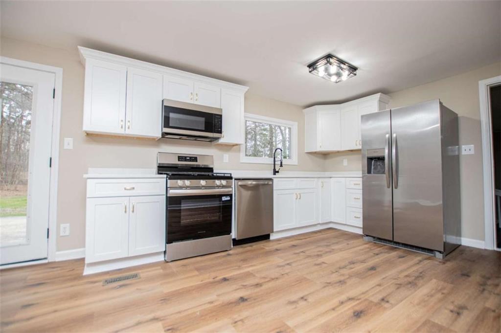 757 North Burnt Hickory Road Douglasville, GA 30134 - Photo 15 of 51 a kitchen with a refrigerator stove and microwave
