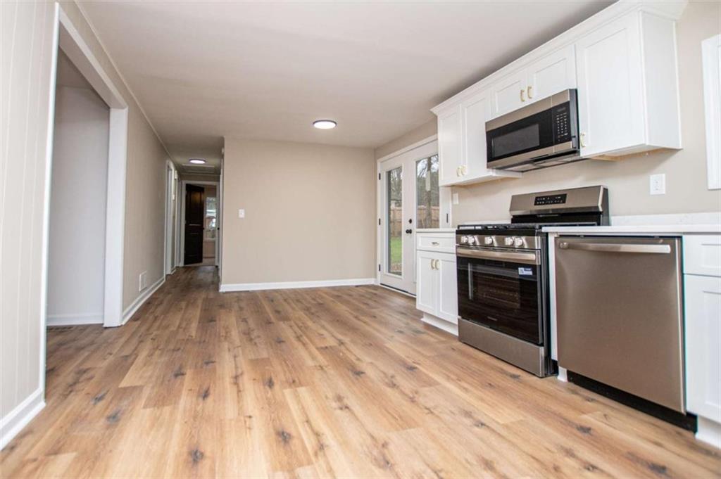 757 North Burnt Hickory Road Douglasville, GA 30134 - Photo 17 of 51 a kitchen with granite countertop a stove top oven and sink