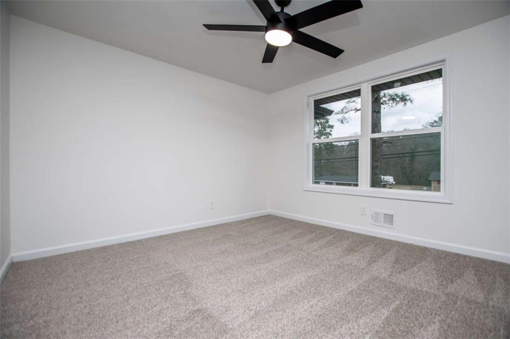 757 North Burnt Hickory Road Douglasville, GA 30134 - Photo 19 of 51 an empty room with windows and fan
