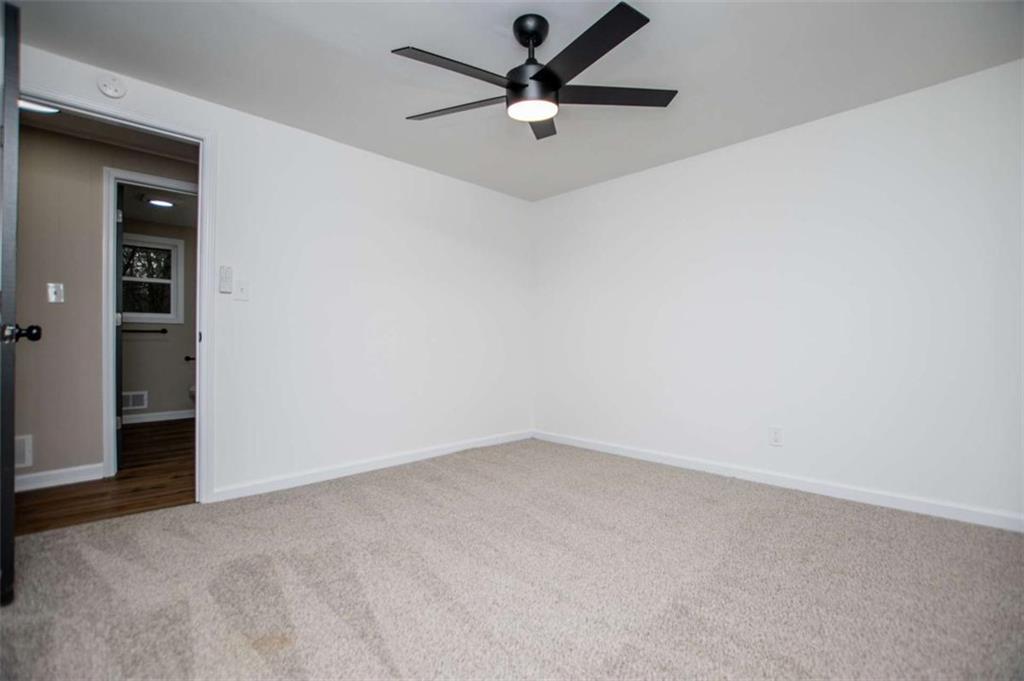 757 North Burnt Hickory Road Douglasville, GA 30134 - Photo 22 of 51 an empty room with a ceiling fan and a window
