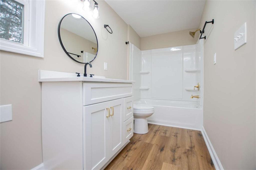 757 North Burnt Hickory Road Douglasville, GA 30134 - Photo 24 of 51 a bathroom with a toilet a sink and a mirror