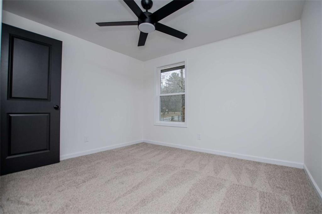 757 North Burnt Hickory Road Douglasville, GA 30134 - Photo 28 of 51 an empty room with a window and a ceiling fan