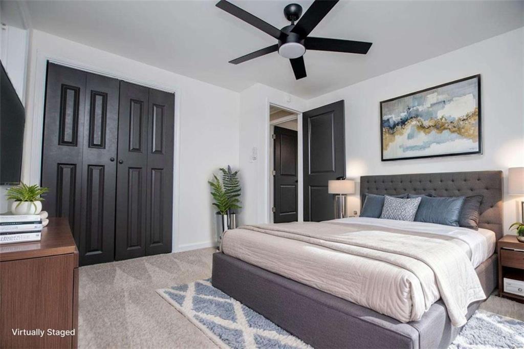 757 North Burnt Hickory Road Douglasville, GA 30134 - Photo 29 of 51 a bedroom with a large bed and a chandelier