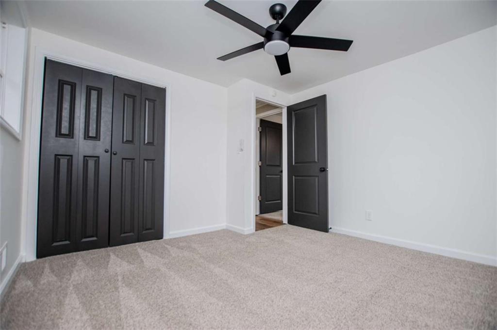 757 North Burnt Hickory Road Douglasville, GA 30134 - Photo 30 of 51 an empty room with ceiling fan and window