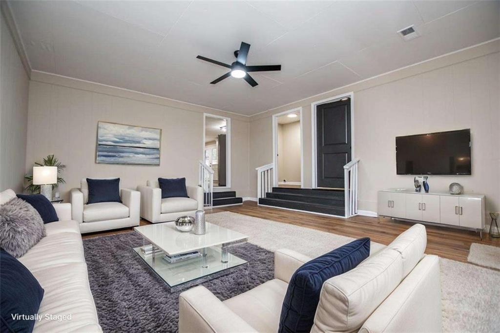 757 North Burnt Hickory Road Douglasville, GA 30134 - Photo 36 of 51 a living room with furniture and a flat screen tv