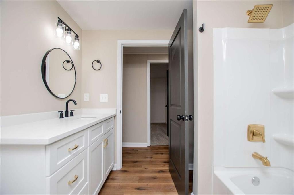 757 North Burnt Hickory Road Douglasville, GA 30134 - Photo 38 of 51 a bathroom with a sink a toilet and shower