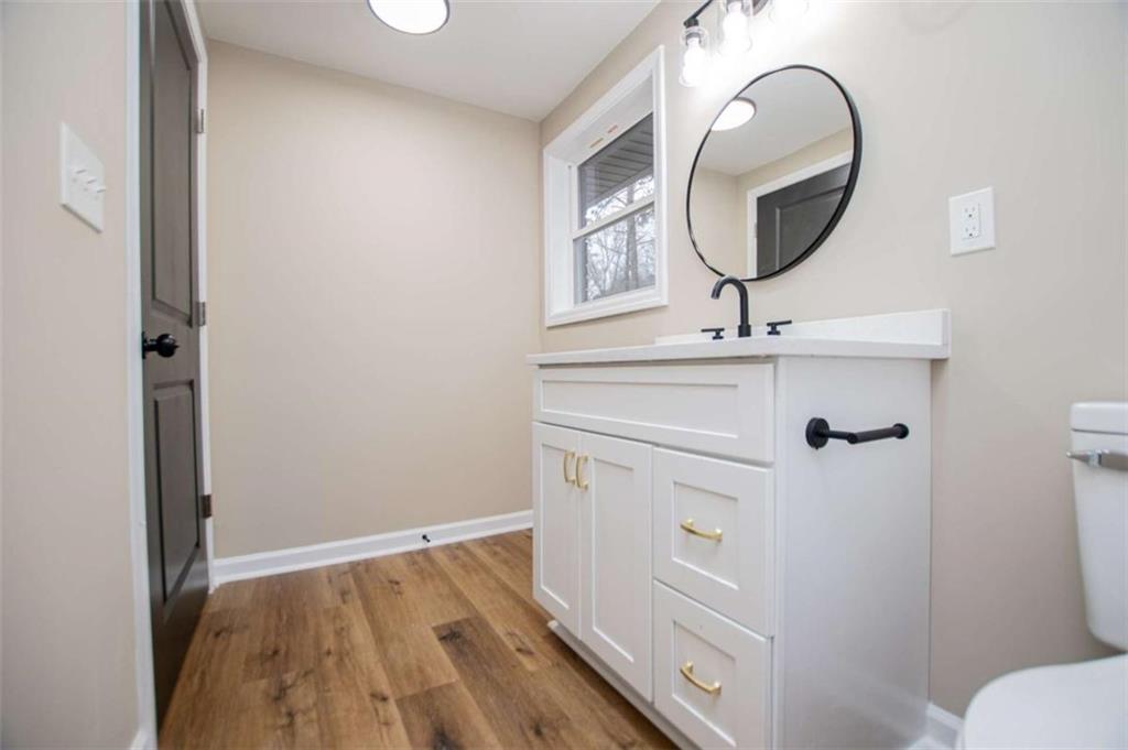 757 North Burnt Hickory Road Douglasville, GA 30134 - Photo 39 of 51 a bathroom with a sink a toilet and a mirror