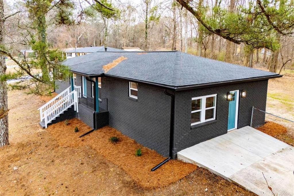 757 North Burnt Hickory Road Douglasville, GA 30134 - Photo 43 of 51 a backyard of a house with wooden fence and a tree