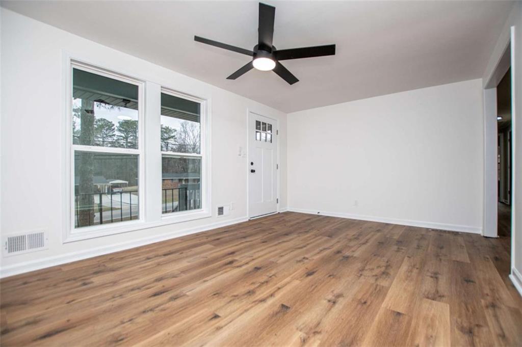 757 North Burnt Hickory Road Douglasville, GA 30134 - Photo 8 of 51 a view of empty room with wooden floor and fan