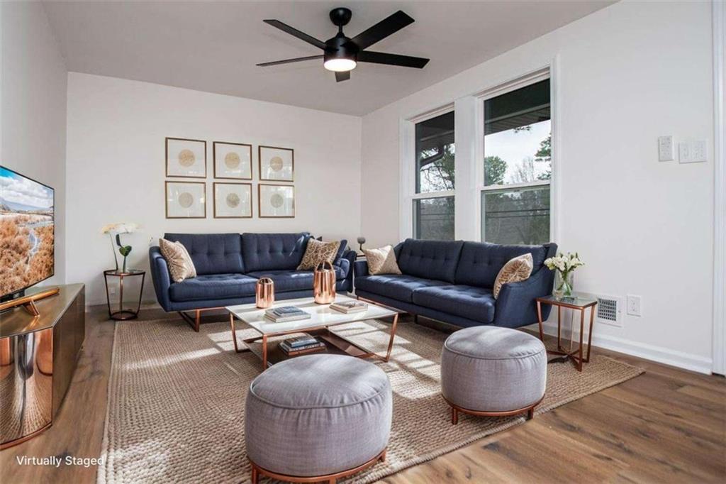 757 North Burnt Hickory Road Douglasville, GA 30134 - Photo 10 of 51 a living room with furniture a ceiling fan and a rug