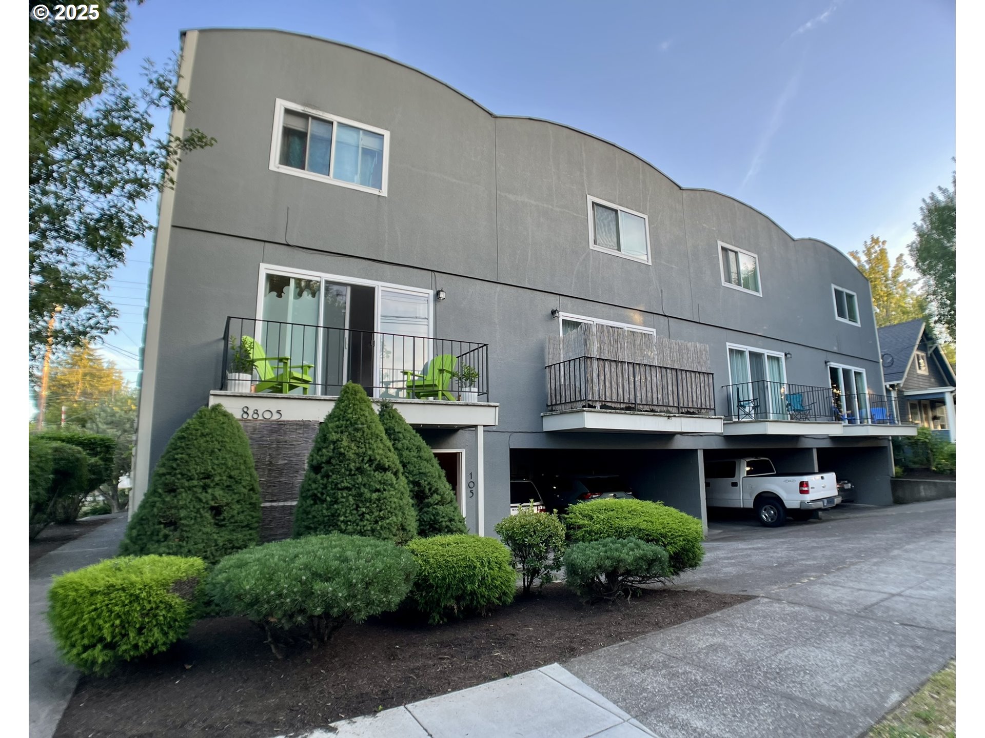 a view of house with a yard and potted plants
