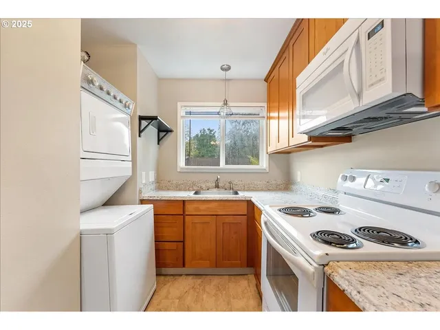 a kitchen with a sink a stove and cabinets
