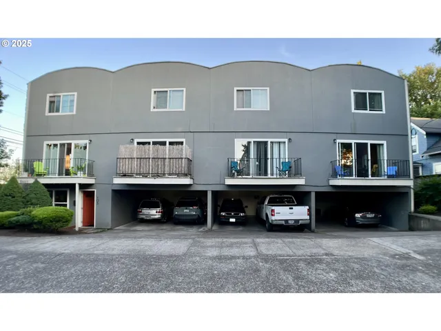 a view of building and car parked in front of house