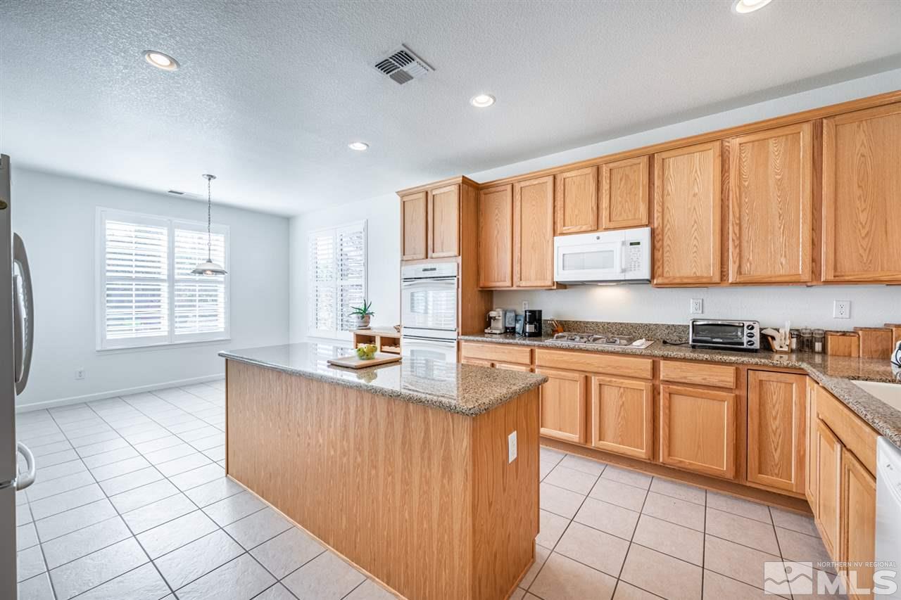 515 Magistrate Court Reno, NV 89521 - Photo 10 of 21 a kitchen with stainless steel appliances granite countertop a stove a sink and a microwave