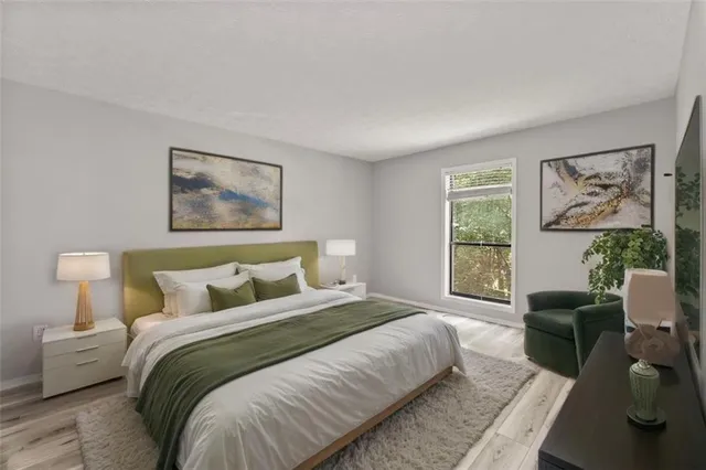 a bedroom with a bed a couch and a window