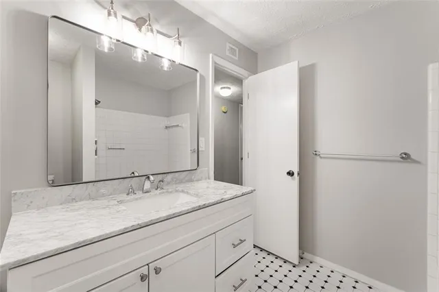 a bathroom with a sink a vanity and a mirror