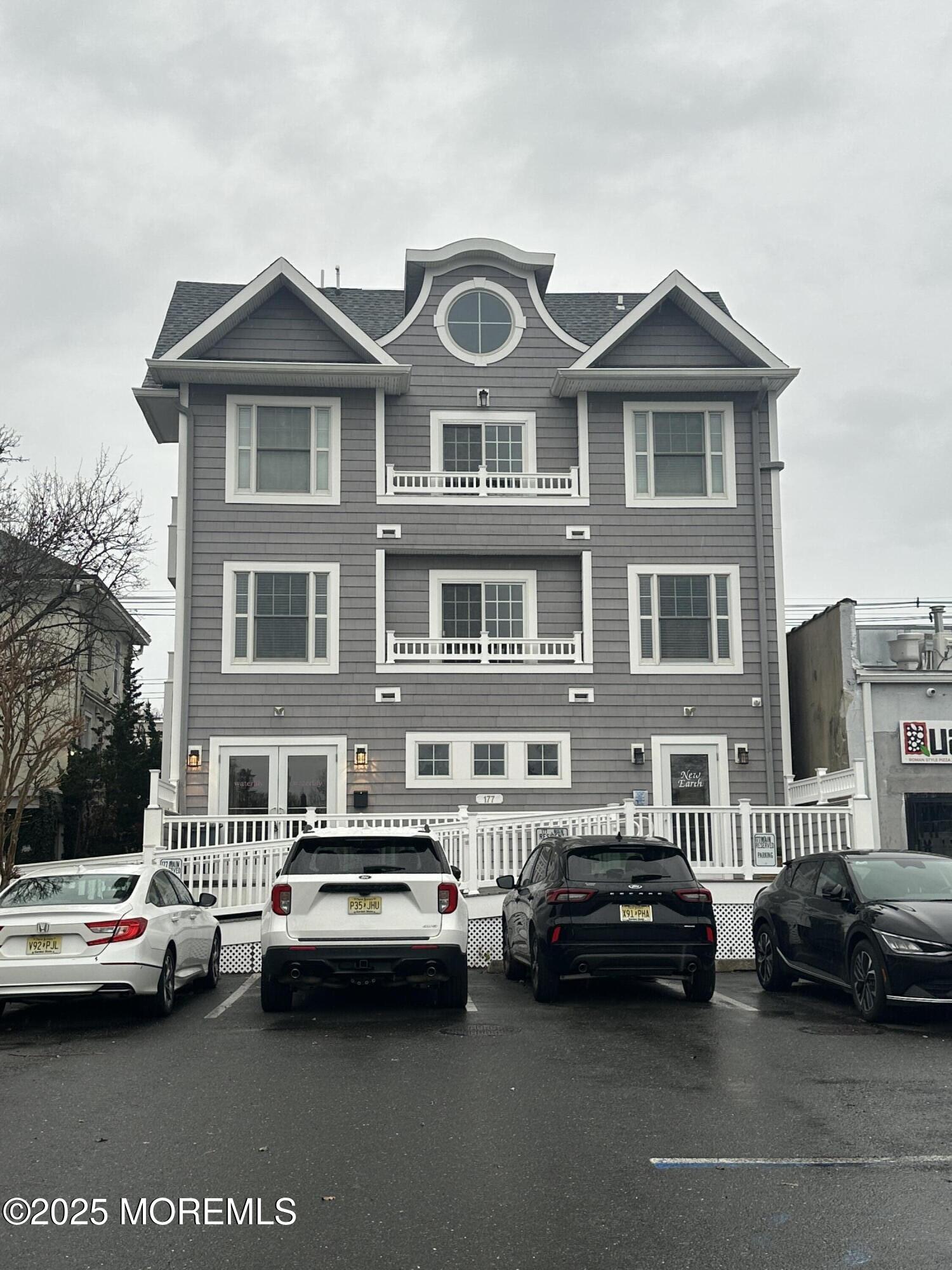 177 Main Street, Unit 2B Manasquan, NJ 08736 - Photo 13 of 13 a couple of cars parked in front of a house