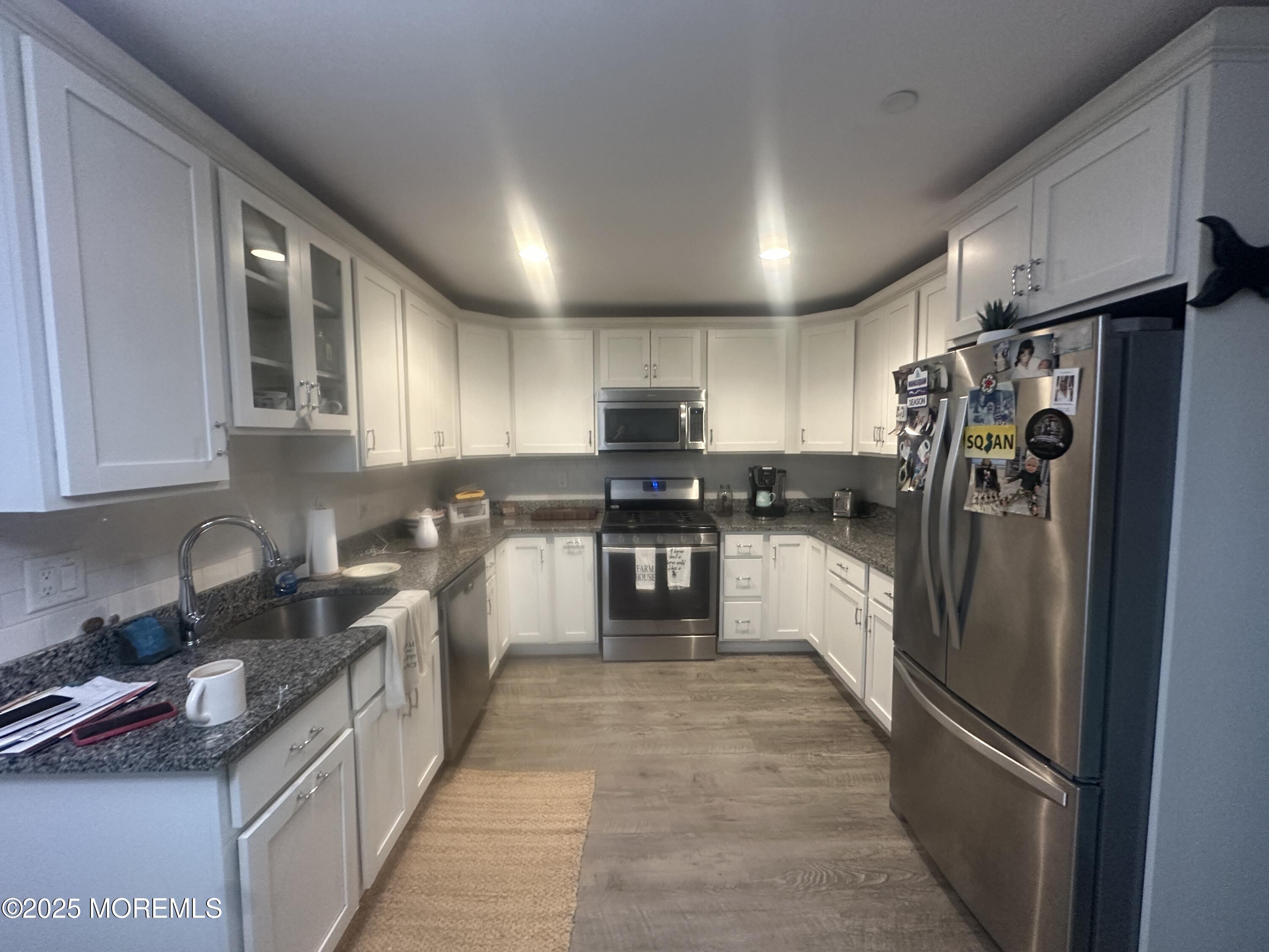 177 Main Street, Unit 2B Manasquan, NJ 08736 - Photo 2 of 13 a kitchen with stainless steel appliances granite countertop a refrigerator and a stove top oven