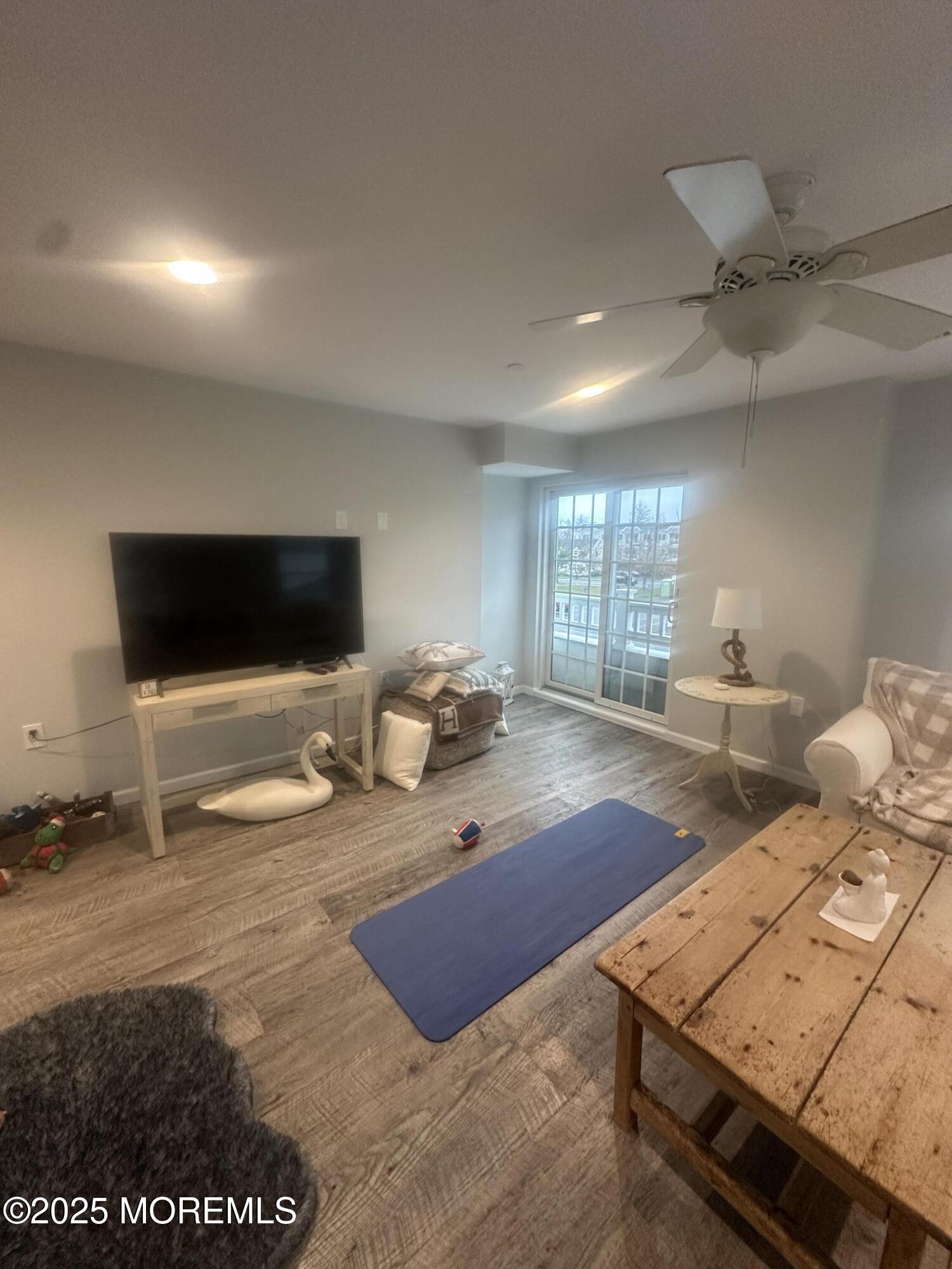 177 Main Street, Unit 2B Manasquan, NJ 08736 - Photo 5 of 13 a living room with furniture and a flat screen tv