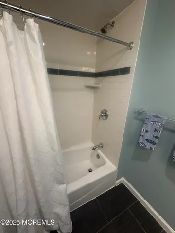a bathroom with a bathtub and shower
