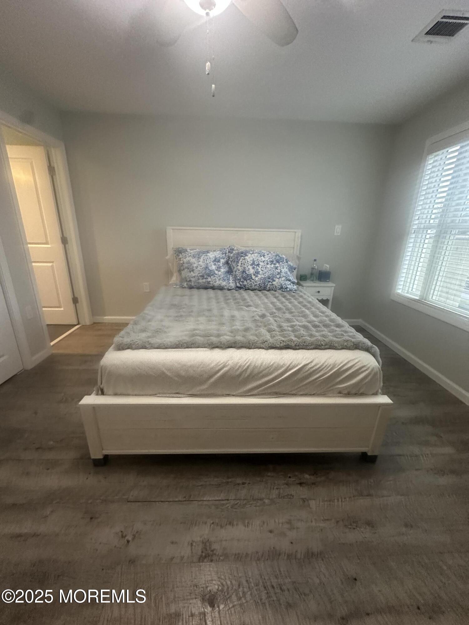 177 Main Street, Unit 2B Manasquan, NJ 08736 - Photo 9 of 13 a spacious bedroom with a bed and windows