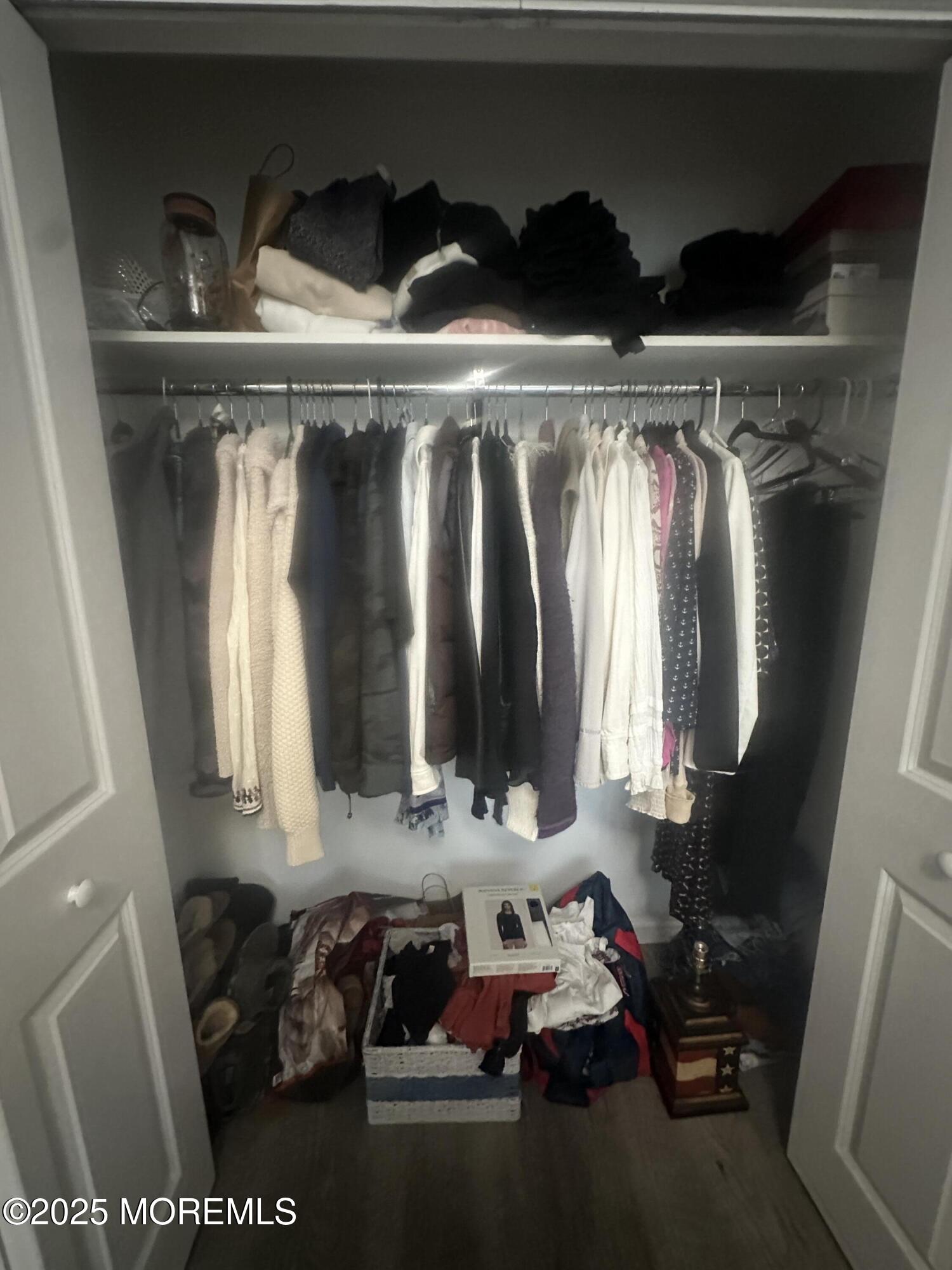 177 Main Street, Unit 2B Manasquan, NJ 08736 - Photo 10 of 13 a view of walk in closet with clothes and shoes
