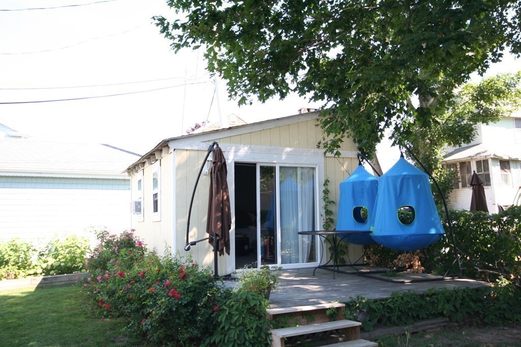 20 Bacon Road Weymouth, MA 02191 - Photo 15 of 26 a view of a house with a small yard and a large tree