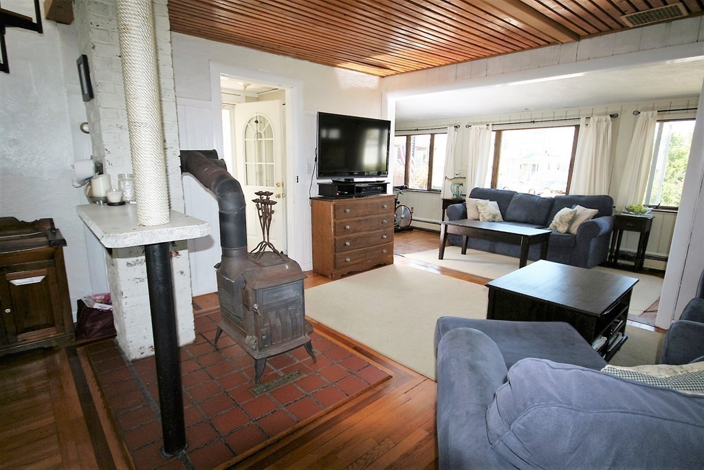 20 Bacon Road Weymouth, MA 02191 - Photo 3 of 26 a living room with furniture and a flat screen tv