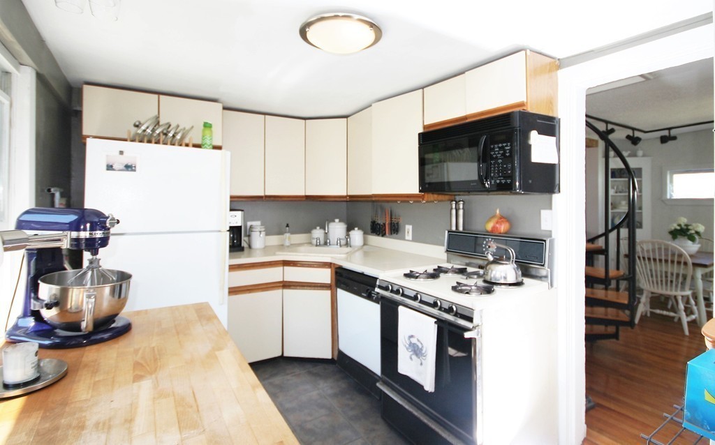 20 Bacon Road Weymouth, MA 02191 - Photo 5 of 26 a kitchen with stainless steel appliances granite countertop a sink stove and refrigerator