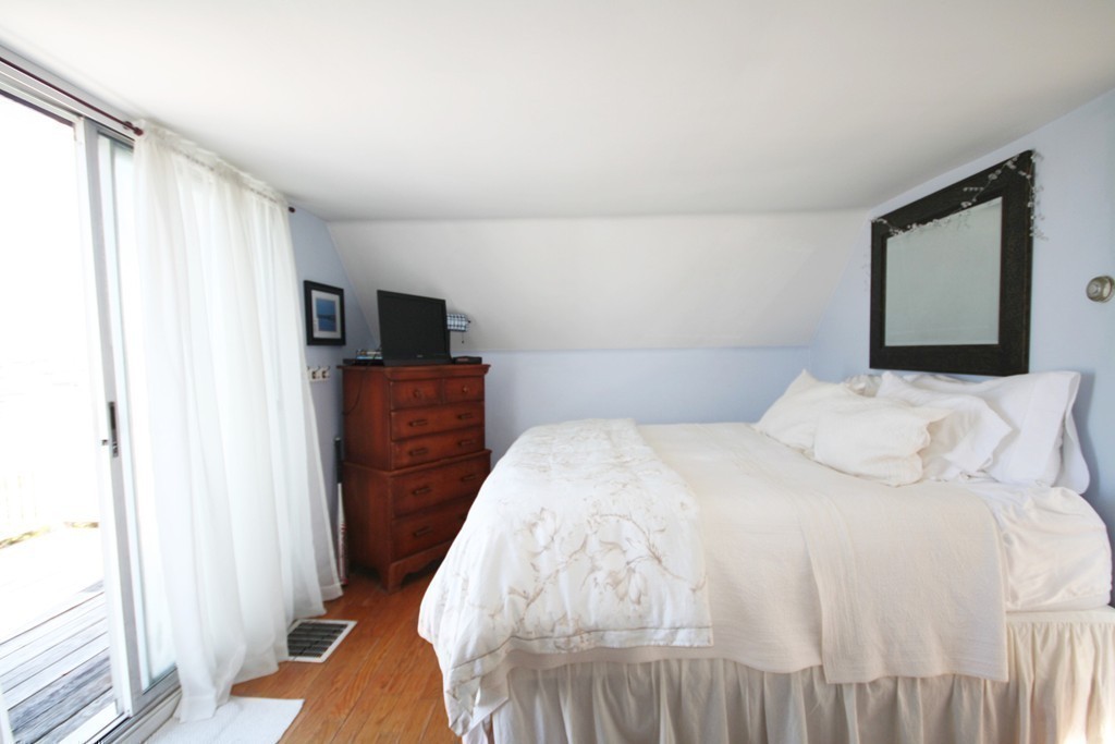 20 Bacon Road Weymouth, MA 02191 - Photo 10 of 26 a bedroom with a bed and a flat screen tv
