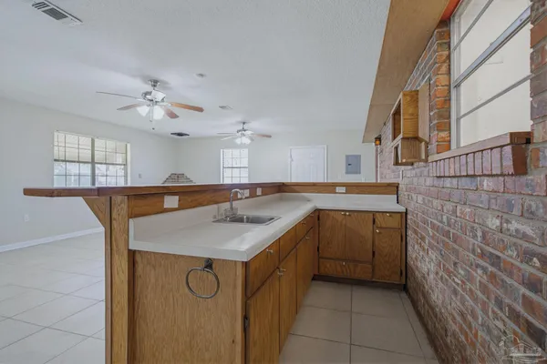 a kitchen with a sink and a refrigerator