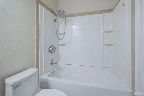 a bathroom with a shower and a toilet