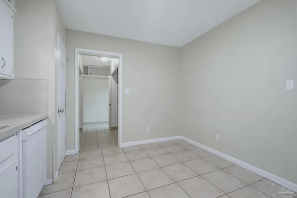 a view of an empty room and closet area