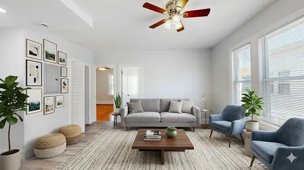 a living room with furniture and a potted plant