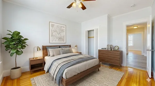 a bedroom with bed and a potted plant