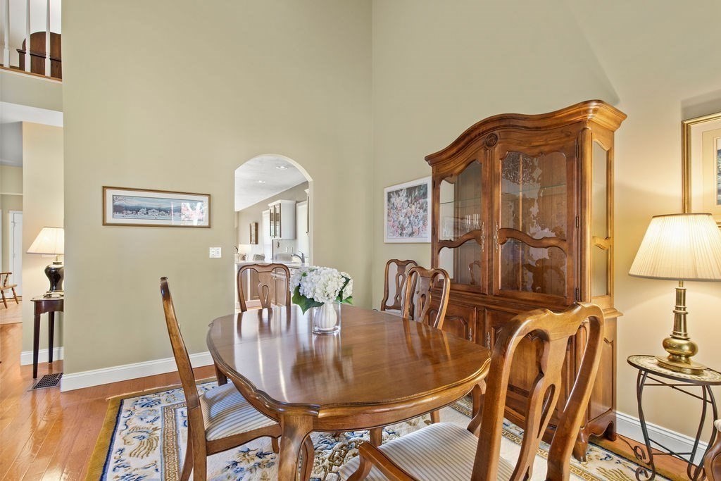 44 Stratford Ridge, Unit 44 Mashpee, MA 02649 - Photo 11 of 40 a view of a dining room with furniture and wooden floor