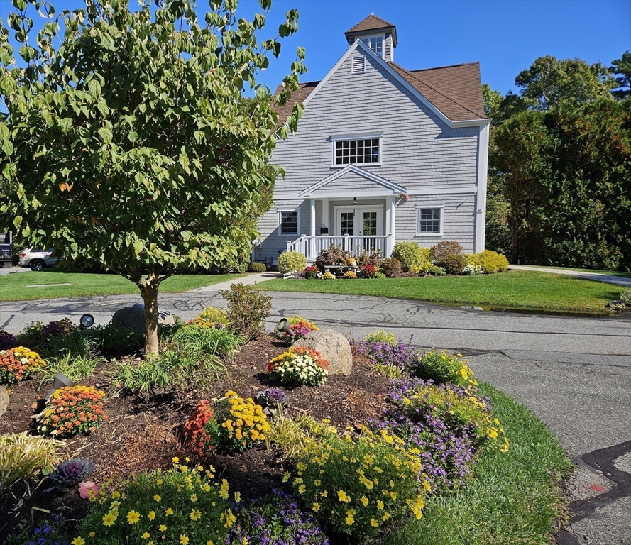 44 Stratford Ridge, Unit 44 Mashpee, MA 02649 - Photo 34 of 40 a front view of a house with a garden