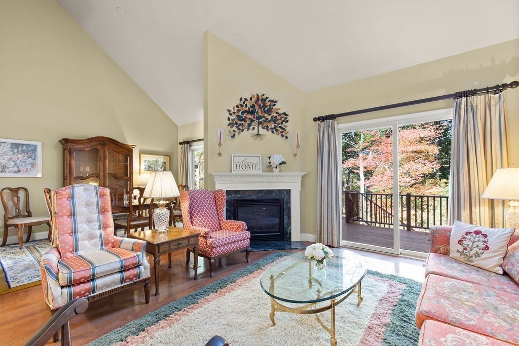 44 Stratford Ridge, Unit 44 Mashpee, MA 02649 - Photo 9 of 40 a living room with furniture a fireplace and a large window